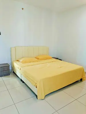 a bed in a room with a yellow blanket on it at Mansion One 3 Bedroom SEAVIEW Gurney Georgetown 1-13Pax in George Town