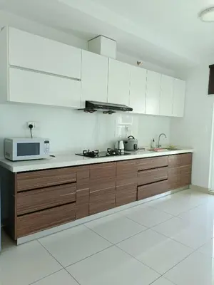 a kitchen with white cabinets and a microwave at Mansion One 3 Bedroom SEAVIEW Gurney Georgetown 1-13Pax in George Town