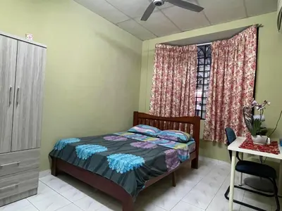 a bedroom with a bed and a dresser and a window at HomestayMuslim Di Teluk Intan in Teluk Intan
