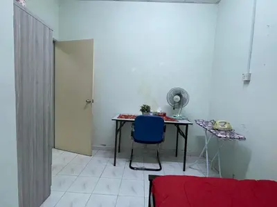 a room with a table and a blue chair at HomestayMuslim Di Teluk Intan in Teluk Intan