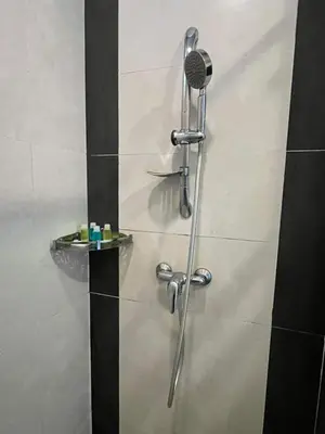 a shower in a bathroom with a glass door at Nova Sunrise n Mountain view Hilltop Hotel apartment in Nova Cameron Highlands in Brinchang
