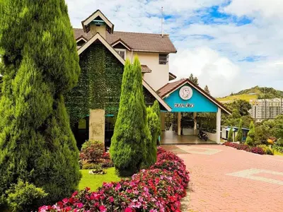 a house with a clock on the front of it at Dear Dino Villa Cameron Highlands in Cameron Highlands