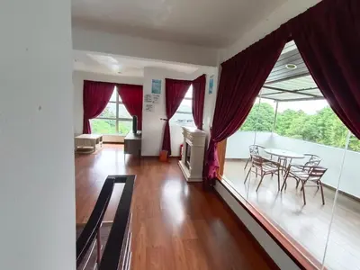 a living room with a table and chairs and a balcony at Dear Dino Villa Cameron Highlands in Cameron Highlands