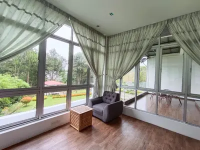 a living room with large windows and a couch at Dear Dino Villa Cameron Highlands in Cameron Highlands