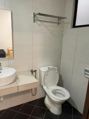 a bathroom with a white toilet and a sink at Marina Heights Hotel Residency in Lumut