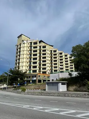 a large apartment building on the side of a road at Marina Heights Hotel Residency in Lumut