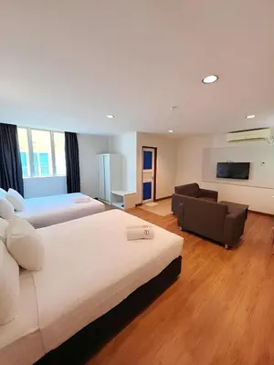 a large bedroom with two beds and a couch at My Hotel Bukit Mertajam in Bukit Mertajam