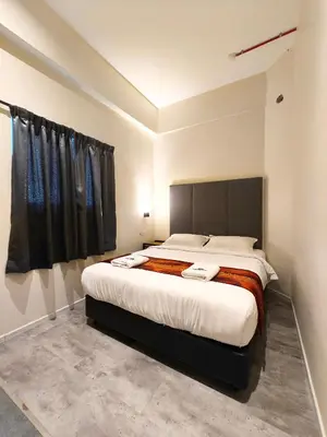 a bedroom with a large bed in a room at Pangkor Pop Ash Hotel in Pangkor