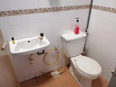 a bathroom with a toilet and a sink at HOMESTAY PERPADUAN, TAMAN BERCHAM RAYA ULU KINTA IPOH PERAK in Kampong Batu Lapan