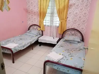 a small room with two beds and a window at HOMESTAY PERPADUAN, TAMAN BERCHAM RAYA ULU KINTA IPOH PERAK in Kampong Batu Lapan