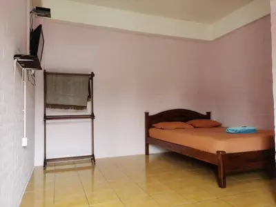 a bedroom with a bed in a room at KAMILA MOTEL TELUK SENANGIN in Lumut