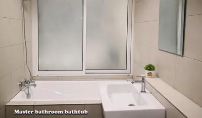 a bathroom with a white sink and two windows at H2H - Octagon Cottage at Ipoh Town Center in Ipoh