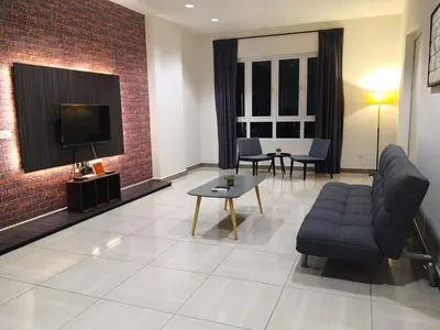 a living room with a couch and a tv at H2H - Octagon Cottage at Ipoh Town Center in Ipoh