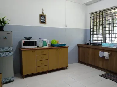a kitchen with a microwave on top of a counter at Afamily Homestay in Ipoh