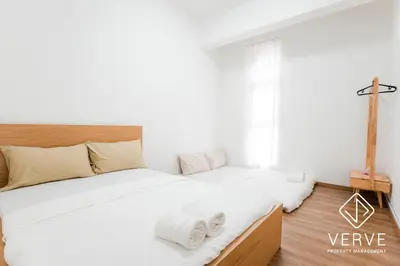 a bedroom with two beds with white sheets at Ipoh Cove Premium Suites by Verve in Ipoh