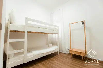 a bedroom with two bunk beds and a mirror at Ipoh Cove Premium Suites by Verve in Ipoh