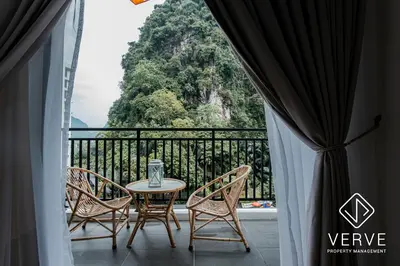 a table and chairs on a balcony with a view at Ipoh Cove Premium Suites by Verve in Ipoh