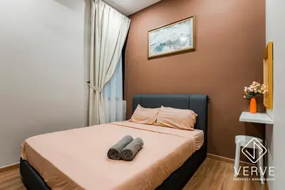 a bedroom with a bed with two towels on it at Ipoh Cove Premium Suites by Verve in Ipoh