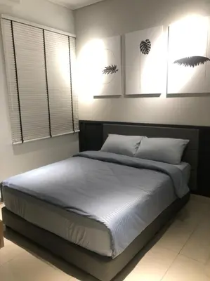 a bedroom with a large bed with white sheets at New Ipoh The Majestic Condo Homestay in Ipoh