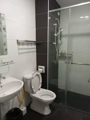 a bathroom with a shower and a toilet and a sink at New Ipoh The Majestic Condo Homestay in Ipoh