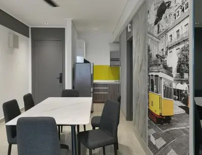 a dining room with a white table and chairs at New Ipoh The Majestic Condo Homestay in Ipoh