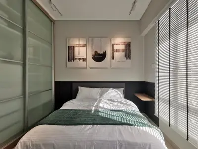 a bedroom with a bed and some pictures on the wall at New Ipoh The Majestic Condo Homestay in Ipoh