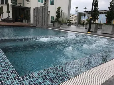 a swimming pool with blue water in a building at Deluxe & Feel Like a Home 2, 3-6pax, Netflix, Georgetown in Jelutong