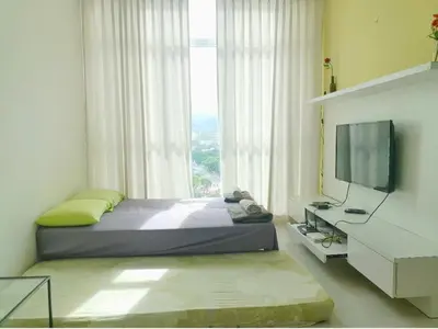 a bedroom with a bed and a tv and a window at Deluxe & Feel Like a Home 2, 3-6pax, Netflix, Georgetown in Jelutong