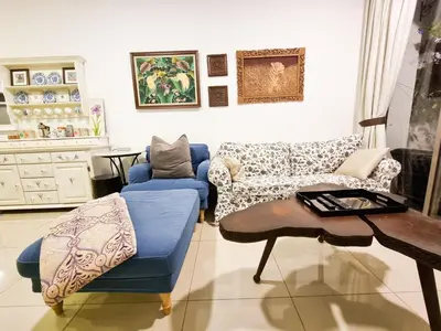 a living room with a blue couch and a table at Mossy Forest Family Retreat, Kea Farm Brinchang in Brinchang