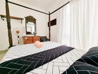 a bedroom with a bed with a pink pillow on it at Mossy Forest Family Retreat, Kea Farm Brinchang in Brinchang