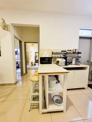 a kitchen with a counter with dishes on it at Mossy Forest Family Retreat, Kea Farm Brinchang in Brinchang