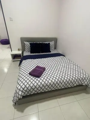 a bed with a purple blanket on it in a room at Cameron Lavender Homestay 3 in Tanah Rata