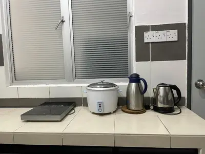a kitchen counter with appliances on a window ledge at Cameron Lavender Homestay 3 in Tanah Rata