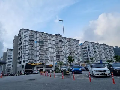 a large building with cars parked in a parking lot at Cameron Lavender Homestay 3 in Tanah Rata