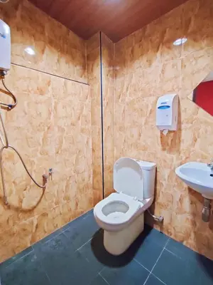 a bathroom with a toilet and a sink at HOTEL YTS in Brinchang