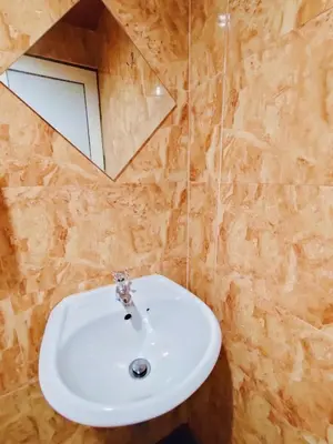 a bathroom with a white sink and a mirror at HOTEL YTS in Brinchang