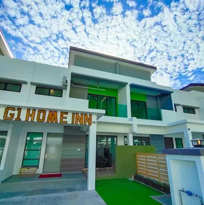 a white house with a home inn sign on it at 61's Home Inn @Pangkor Villa 88 Resort in Kampong Sungai Udang