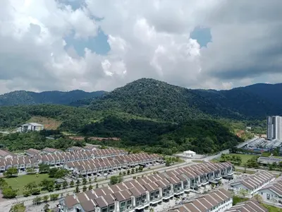 an aerial view of a city with mountains in the background at Muslim Apartment at Meru in Ipoh