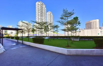 a park in the middle of a city with tall buildings at The Landmark Penang in Tanjong Tokong