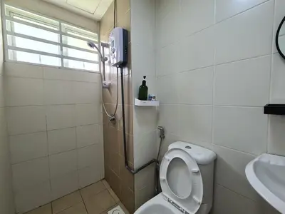 a bathroom with a shower and a toilet and a sink at The Simplicity Homestay in Tanah Rata