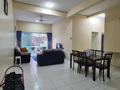 a living room with a table and chairs at The Simplicity Homestay in Tanah Rata
