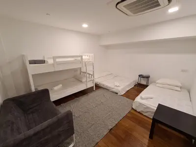 a living room with two beds and a chair at Sunrise Gurney Premium Executive City/Seafront suite - Penang in George Town
