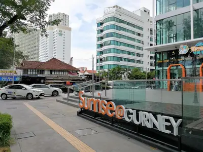 a parking lot with cars parked in a city at Sunrise Gurney Premium Executive City/Seafront suite - Penang in George Town