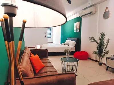 a living room with a couch and a bed at THE LANDMARK BY KATANA New 3BR Grand Seaview Homestay at Gurney \u65e0\u654c\u6d77\u666f\u4e09\u623f\u5957\u623f in Tanjung Bungah