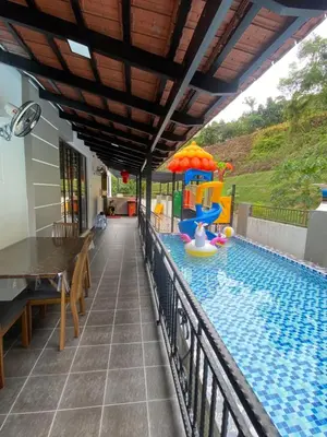 a swimming pool with a table and a play structure at 50PAX 9BR Villa Kids Swimming Pool, KTV, BBQ n Pool Tables near SPICE Arena Penang 9800 SQFT in Bayan Lepas