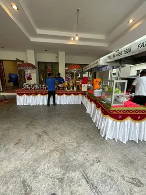 a man standing in front of a counter in a store at 50PAX 9BR Villa Kids Swimming Pool, KTV, BBQ n Pool Tables near SPICE Arena Penang 9800 SQFT in Bayan Lepas