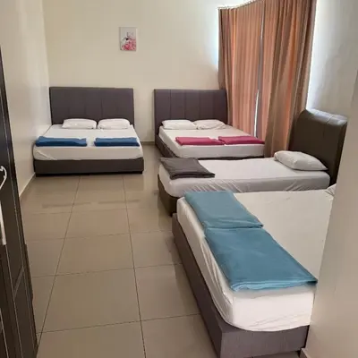 a room with three beds in it at 18PAX 4BR Villa with Kids Swimming Pool, KTV, BBQ near SPICE Arena Penang in Bayan Lepas