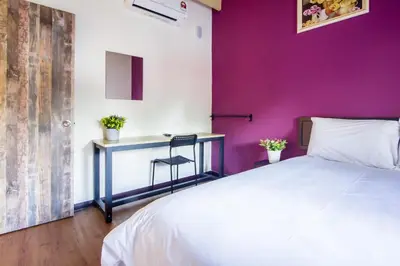 a bedroom with a white bed and a desk at Explore 5BR Gardenhouse Retreats (Free Parking) in Butterworth