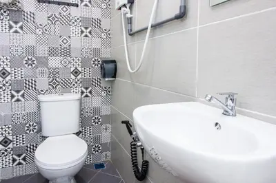 a bathroom with a toilet and a sink at Explore 5BR Gardenhouse Retreats (Free Parking) in Butterworth