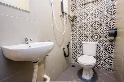 a bathroom with a sink and a toilet at Explore 5BR Gardenhouse Retreats (Free Parking) in Butterworth